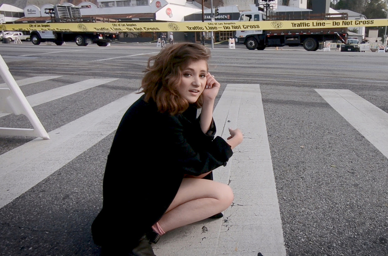Noël Wells runs through the streets in new “Played for Keeps” video